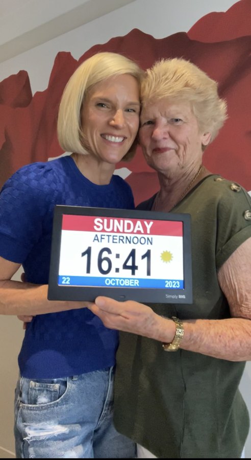 Mother and daughter holding the clock