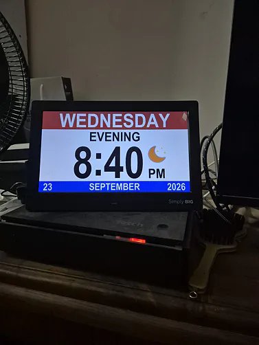 Customer photo of the clock on a shelf at night showing Wednesday evening 8:40 PM